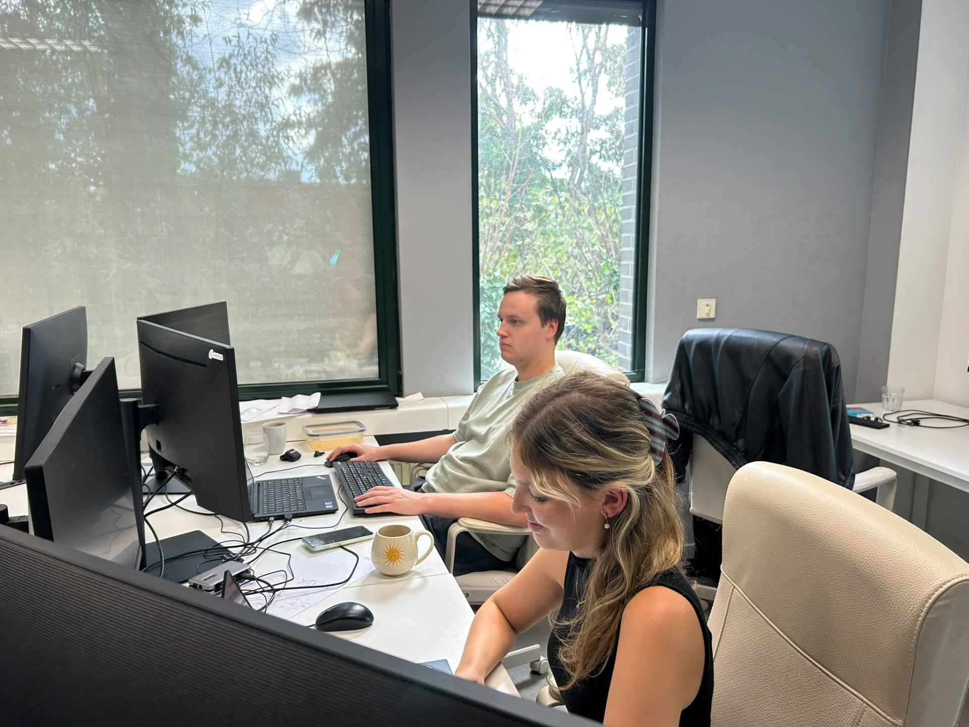 Het AMOTEK-team werkt samen rond computers